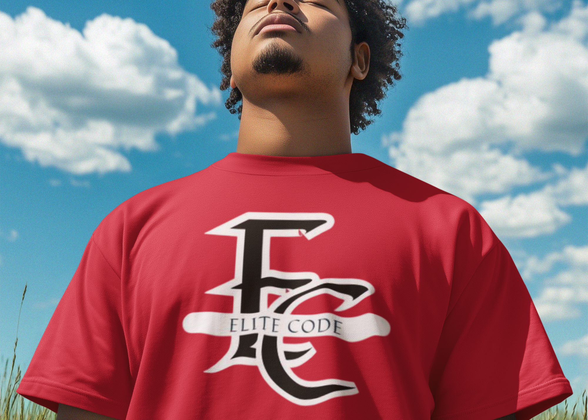 Person wearing a red 'Elite Code' t-shirt against a blue sky with white clouds